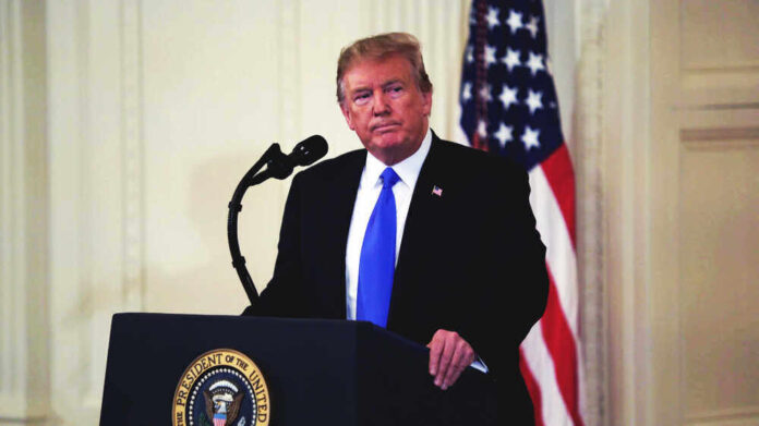 shutterstock_1326218579.jpg featured image Donald Trump speaking at podium.