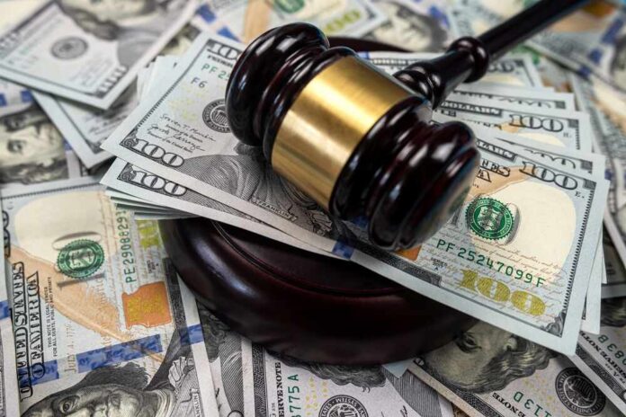 shutterstock_2264281137.jpg featured image Gavel on pile of hundred dollar bills