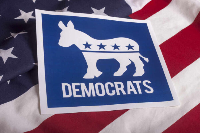 shutterstock_3058522133.jpg featured image Democratic Party donkey logo on American flag background.