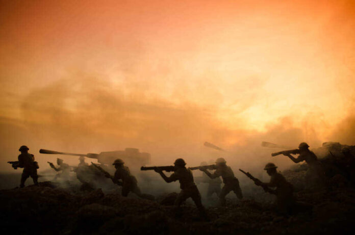 shutterstock_662146207.jpg featured image Silhouettes of soldiers advancing at sunset.