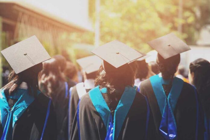shutterstock_735270478.jpg featured image Graduates wearing caps and gowns in ceremonial procession.