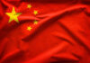 Chinese flag with five yellow stars.