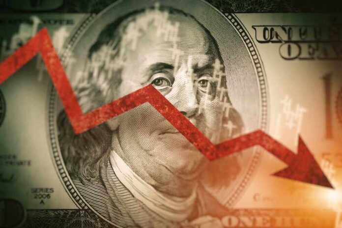 shutterstock_2090787709-1.jpg featured image Red downward arrow over Benjamin Franklin on US dollar.