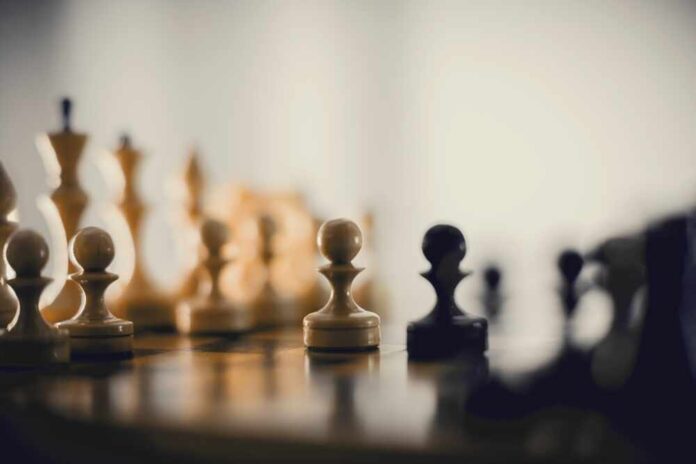 shutterstock_2483316369.jpg featured image Chess pieces on a board blurred background