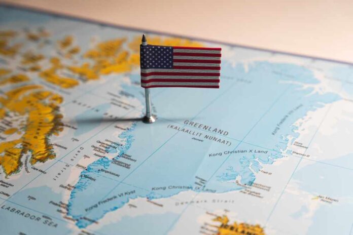 shutterstock_2573993557.jpg featured image USA flag on a map of Greenland