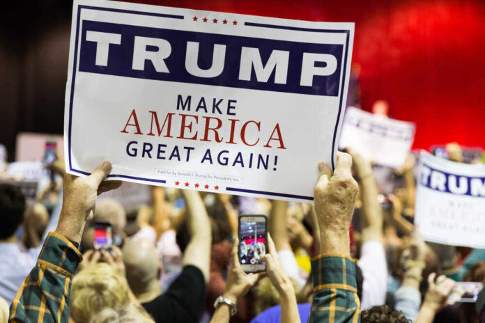 shutterstock_382158925.jpg featured image People holding Trump Make America Great Again signs.