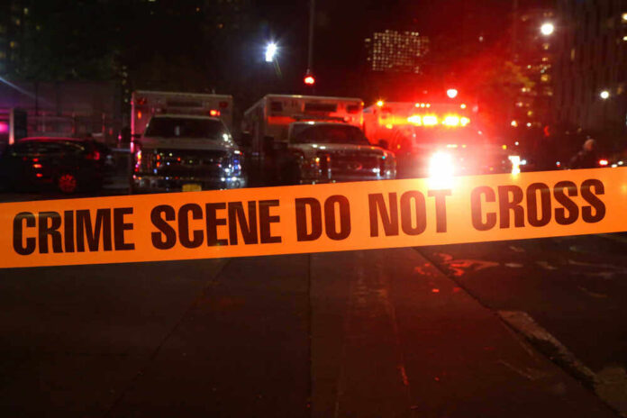 shutterstock_746018290.jpg featured image Crime scene tape with emergency vehicles in background.