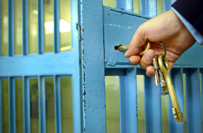 shutterstock_789621847.jpg featured image Hand unlocking blue metal door with keys.