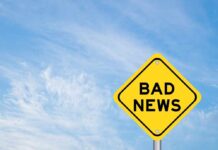 Yellow sign reads bad news in sky