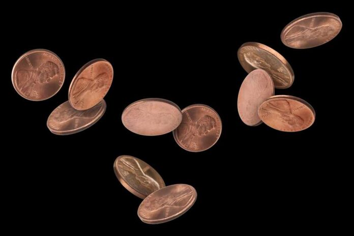 shutterstock_2499160707.jpg featured image Floating copper coins against a black background
