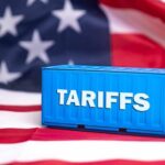 Shipping container reading tariffs on the American flag