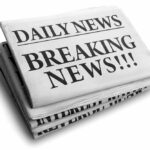 Stack of newspapers with breaking news headline