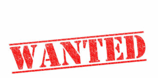 Red WANTED stamp on white background.