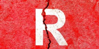 Cracked red wall with white letter R.