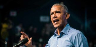 Barack Obama speaks at podium.