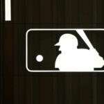 MLB logo with a baseball player silhouette
