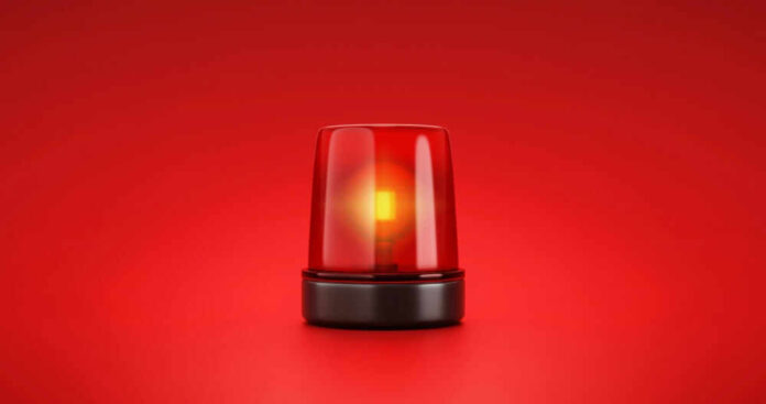 shutterstock_2053758056.jpg Red emergency light on red background