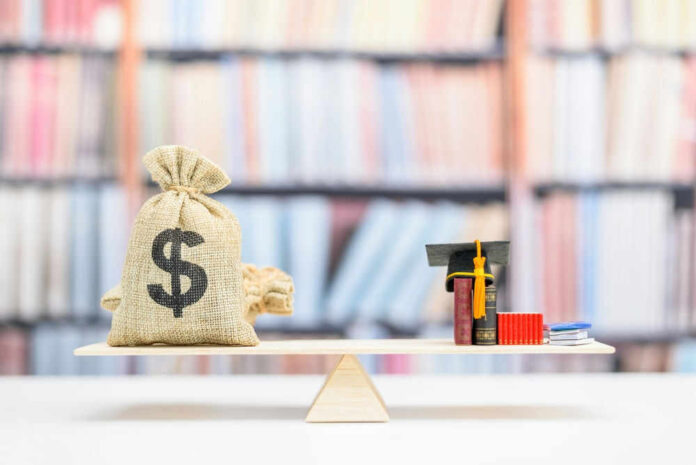 shutterstock_2149850041.jpg Money bag and books balanced on a seesaw.