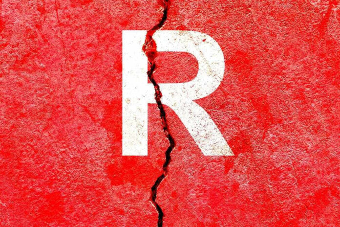 shutterstock_2222197027.jpg Cracked red wall with white letter R.
