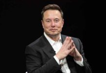 Elon Musk in a suit talking.