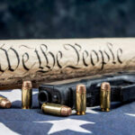 Trump’s Gun Order Shocks Liberals Gun, bullets, Constitution scroll on American flag