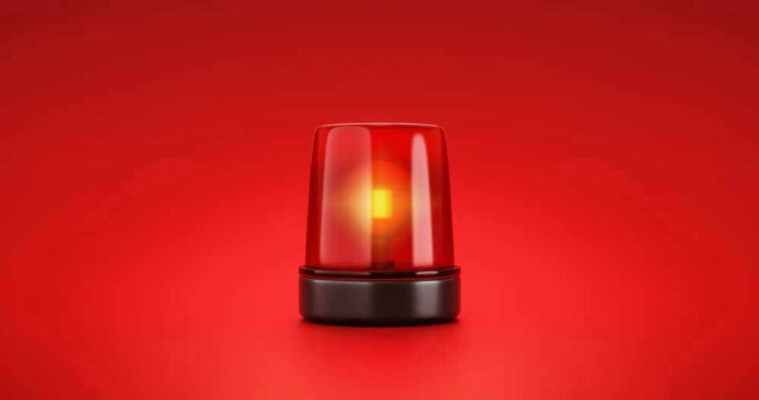 Red emergency light on solid red background