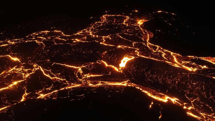 Glowing lava flow at night forming intricate patterns