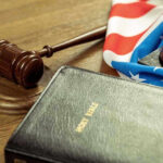 Gavel, Holy Bible, and American flag on a desk