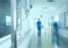 Hospital corridor with IV drip and healthcare worker