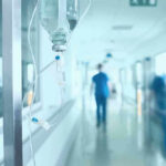 Hospital corridor with IV drip and healthcare worker