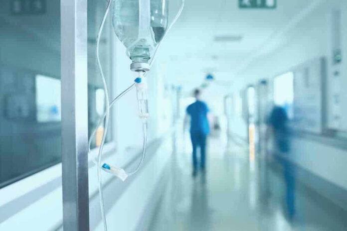 Hospital corridor with IV drip and healthcare worker