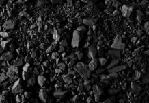 Close-up of black coal pieces scattered on a surface