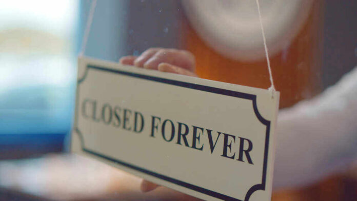 Closed forever sign being placed on window
