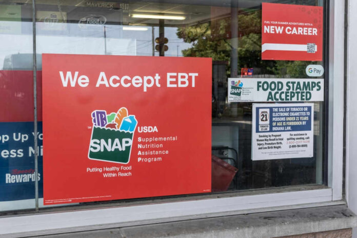 shutterstock_2341195625.jpg Store window displays EBT and SNAP acceptance signs