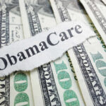 ObamaCare text over money background.