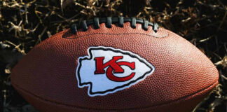 Kansas City Chiefs football lying on the grass.