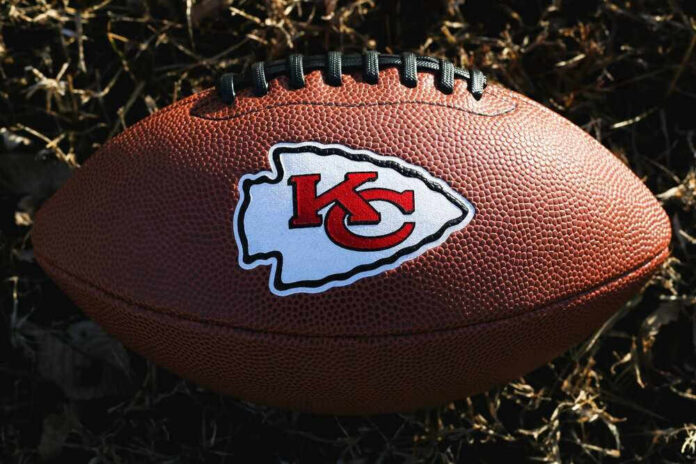 Kansas City Chiefs football lying on the grass.
