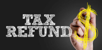 Hand writing 'TAX REFUND' with a dollar sign