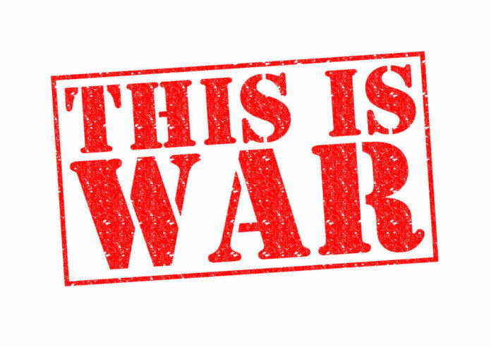 A bold red stamp with the text 'THIS IS WAR'