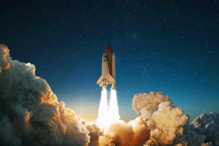 shutterstock_1574090395.jpg Space shuttle launching into a starry night sky.