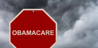 Red stop sign labeled Obamacare cloudy sky background