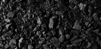Close-up of black coal pieces scattered on a surface