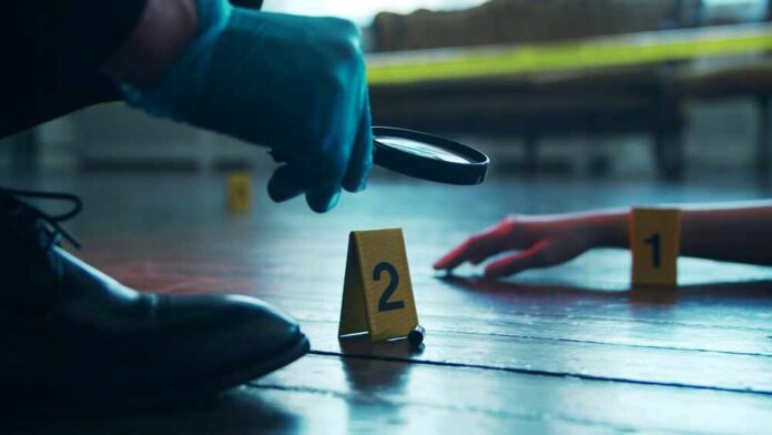 A detective examining evidence at a crime scene with markers on the floor