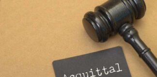 A gavel next to a card that reads 'Acquittal'