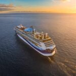 Elderly Woman’s SHOCKING Cruise Ship Act Stuns Coast Guard A cruise ship sailing on calm waters during sunset