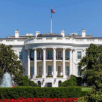 Maxwell Pardon Demands Killed at White House Briefing White House with trees and fountain.