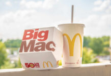A Big Mac box next to a McDonald's drink cup on a ledge