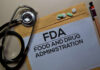 Stethoscope and medication on a folder labeled FDA