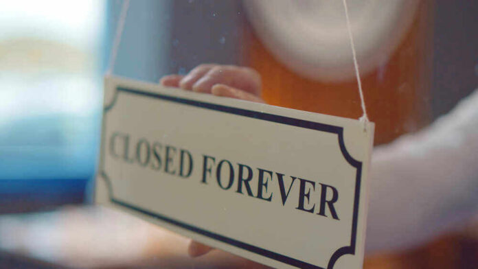 Closed forever sign being placed on window.