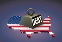 A heavy weight labeled 'DEBT' sits on a map of the United States, symbolizing economic challenges.